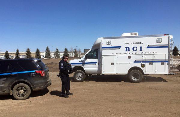 State and local police search a field in Manton, N.D., on April 3, 2019 ,about half a mile from a business where an owner and three employees were found dead, Authorities on Thursday said they were looking for "potential evidence" related to the deaths discovered Monday at RJR Maintenance and Management in Mandan, a city just outside Bismarck. (Blake Nicholson/AP Photo)