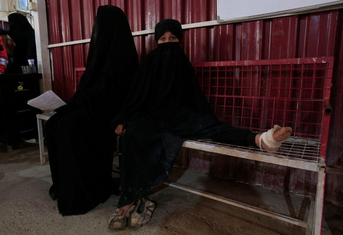 A wounded girl sits at a clinic at al-Hol displacement camp in Hasaka governorate, Syria, on April 2, 2019. (Ali Hashisho/Reuters)