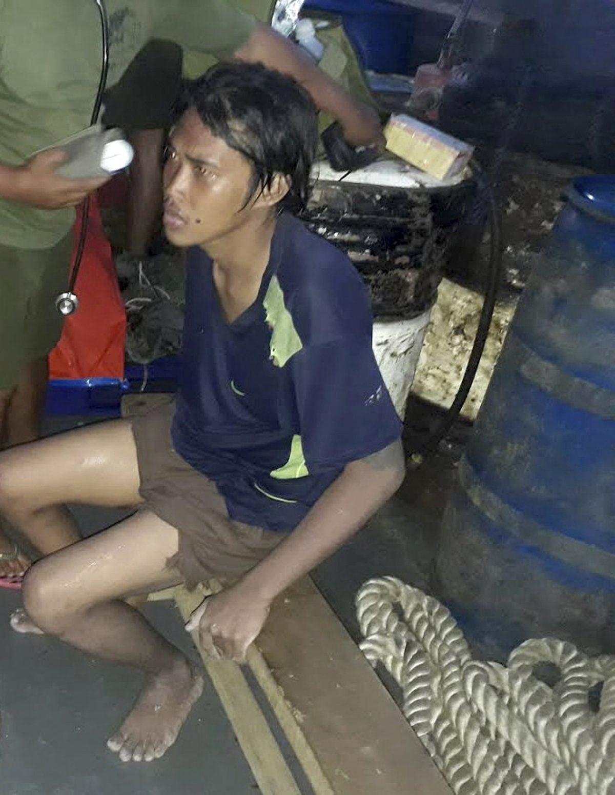 Indonesian hostage Heri Ardiansyah sits on a cot inside a Philippine Navy patrol boat following his rescue by Philippine troops on Simisa island, Sulu Province in the southern Philippines, on April 5, 2019. (WestMinCom Armed Forces of the Philippines via AP)