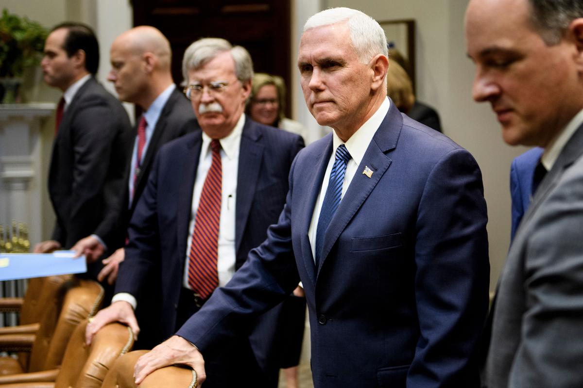 Vice President Mike Pence waits with national security adviser John Bolton and others before a meeting with Fabiana Rosales de Guaido, wife of Venezuela's self-proclaimed interim President Juan Guaido, at the White House, on March 27, 2019. (BRENDAN SMIALOWSKI/AFP/Getty Images)