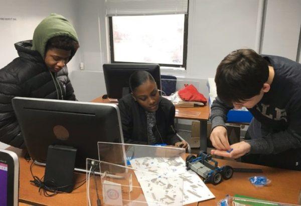 Daniel Flyer (R) puts together pieces using a robotics kit at the Woman’s Opportunity Rehabilitation Center’s After-School Tutorial Program. (Photo by Karen Flyer)