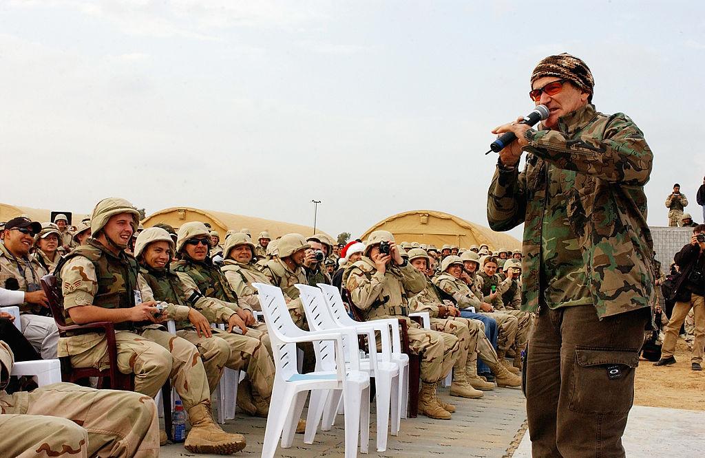 Actor/comedian Robin Williams entertains the troops during the United Service Organizations (USO) tour at Baghdad International Airport. (©<a href="https://www.gettyimages.com/detail/news-photo/actor-comedian-robin-williams-entertains-the-troops-during-news-photo/2818546">Getty Image</a>)