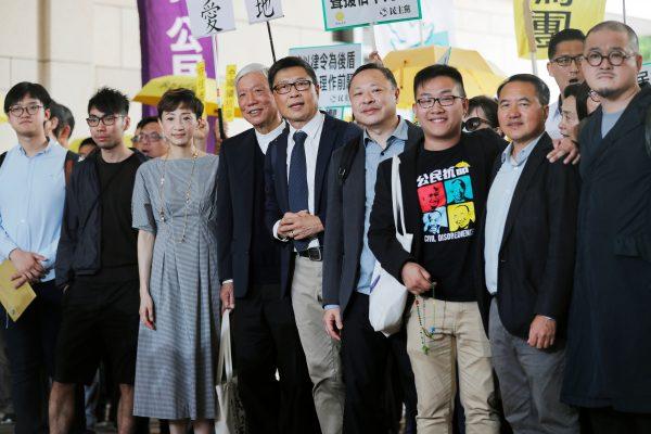 (L-R) Pro-democracy activists Cheung Sau-yin, Chung Yiu-wa, Tanya Chan, Chu Yiu-ming, Chan Kin-man, Benny Tai, Raphael Wong, Lee Wing-tat, and Shiu Ka-chun arrive at the court before a verdict on their involvement in the Occupy Central, also known as "Umbrella Movement" in Hong Kong on April 9, 2019. (Tyrone Siu/Reuters)