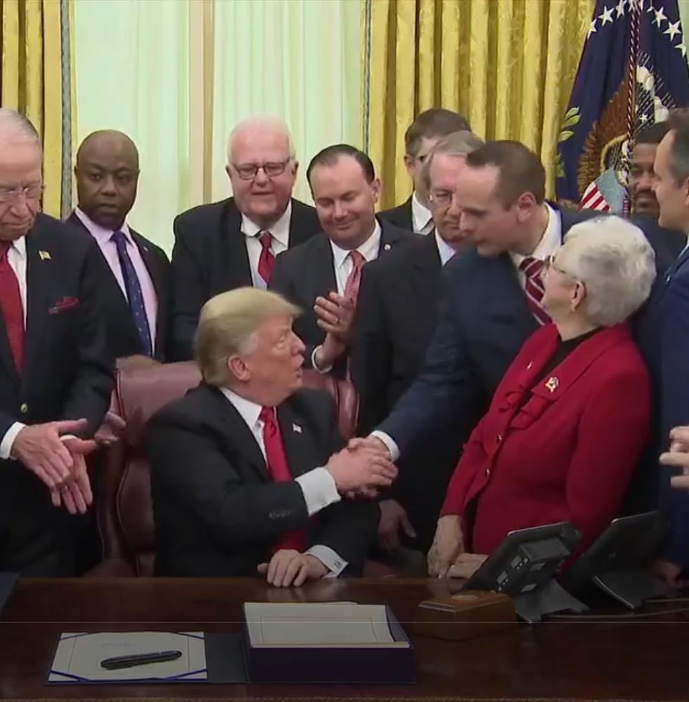 President Donald Trump shakes John Koufos's hand at the signing ceremony for the First Step Act in the Oval Office in Washington on Dec. 21, 2018. (Courtesy John Koufos)