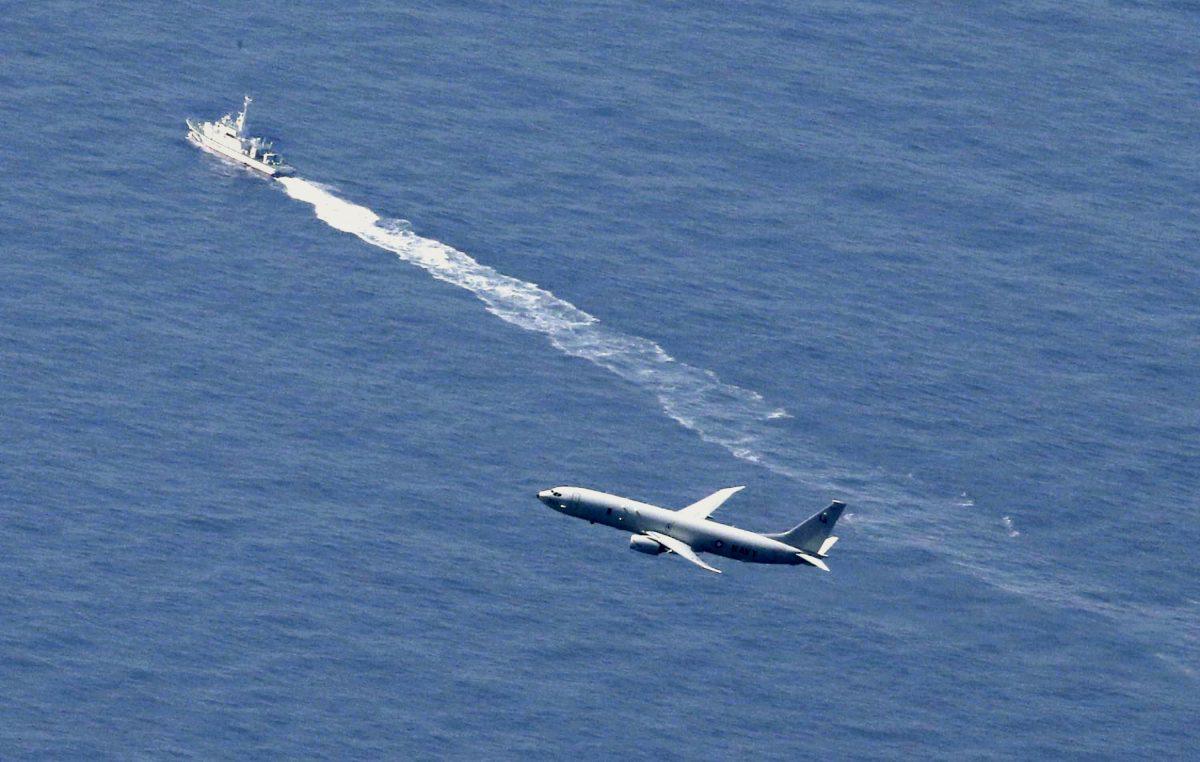 A Japan Coast Guard vessel and a U.S. military aircraft conduct rescue and search operations on April 10, 2019, at the site where an Air Self-Defense Force's F-35A stealth fighter jet crashed during an exercise on April 9, 2019, off Aomori Prefecture, Japan. (Kyodo/Reuters)