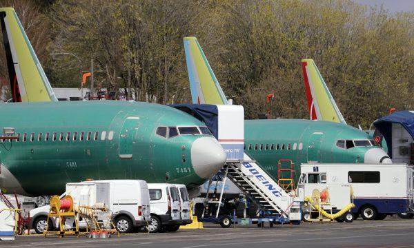 Boeing 737 Max 8 jets, built for American Airlines, left, and Air Canada are parked at the airport adjacent to a Boeing Co. production facility in Renton, Wash. on April 8, 2019. (Elaine Thompson/File photo via AP)