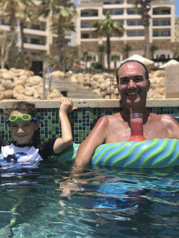 Son Jake (left) and Jim in the pool at a resort in Cabot last summer. The resort was relatively new so it had everything necessary for disabled people to get into the pool (a chair with crane). (Photo courtesy of Jenielle Ravenna)