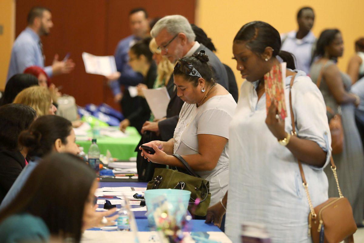 People attend a job fair put on by Miami-Dade County and other sponsors in Miami, Fla., on April 05, 2019. (Joe Raedle/Getty Images)