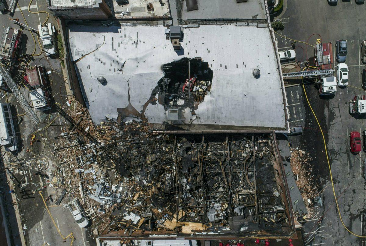 In this aerial image taken on April 10, 2019, firefighters battle a fire at the scene of an explosion in Durham, N.C. (Travis Long/The News & Observer via AP)