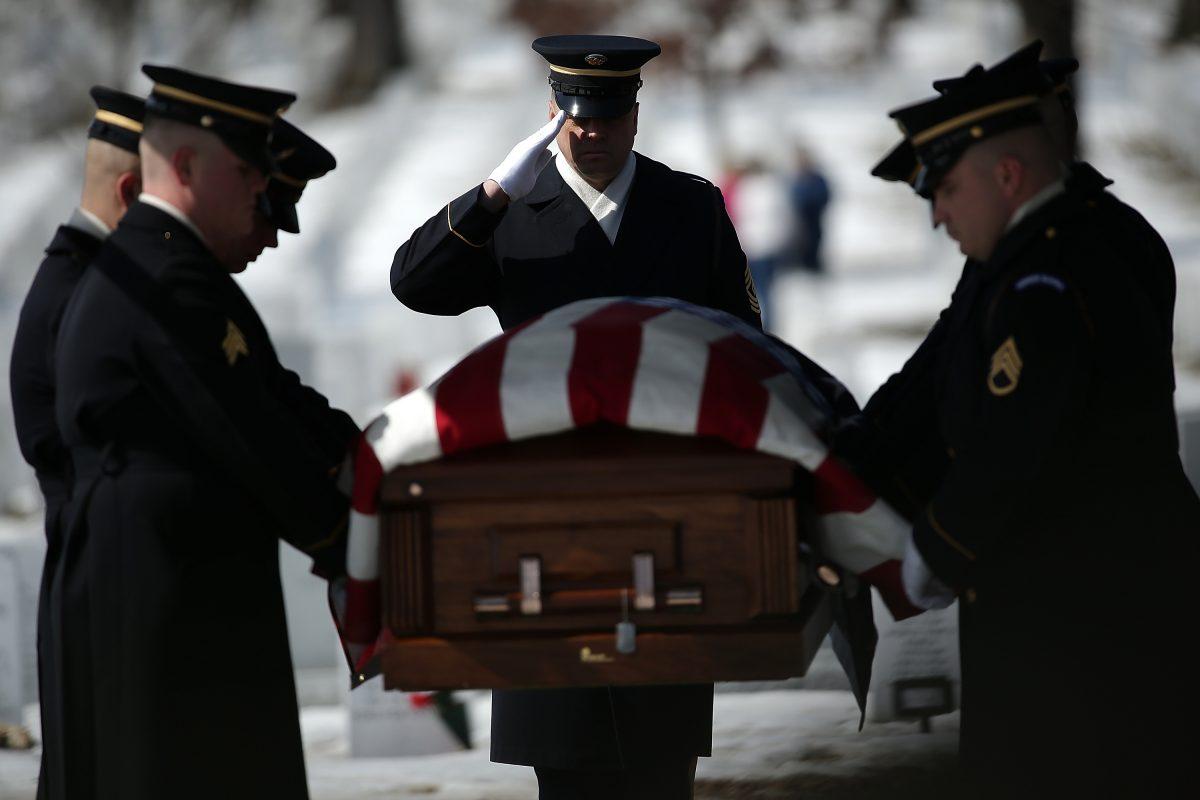 An honor guard moves the remains of U.S. Army Air Forces Tech Sgt. Charles Johnston to his burial site at Arlington National Cemetery in Arlington, Va., on March 2, 2015. (Win McNamee/Getty Images)