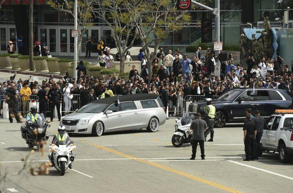 A silver hearse carrying the body of Nipsey Hussle, whose given name was Ermias Asghedom, leaves the Staples Center in a procession following the Celebration of Life memorial service for the late rapper on April 11, 2019, at the Staples Center in Los Angeles. (Chris Pizzello/Invision/AP)