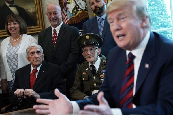 President Donald Trump speaks as he meets with World War II veterans including Paul Kriner (2nd L) and Floyd Wigfield (3rd L) in the Oval Office of the White House in Wash., DC, on April 11, 2019. (Alex Wong/Getty Images)