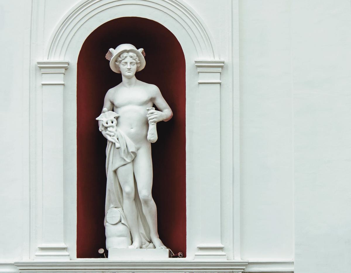 A statue of Hermes on the façade of the Yeliseyevsky store, in St. Petersburg, Russia. Hermes is considered the trickster god, the god of luck, and the god of fraud, merchants, and thieves. (Karasev Victor/Shutterstock)
