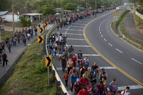 Central American migrants, part of the caravan hoping to reach the U.S. border, walk on the shoulder of a road in Frontera Hidalgo, Mexico, on April 12, 2019. (Isabel Mateos/Photo via AP)