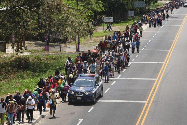 Central American migrants, part of a caravan hoping to reach the United States border, walk on the shoulder of a road in Frontera Hidalgo, Mexico, on April 12, 2019. (Isabel Mateos/Photo via AP)