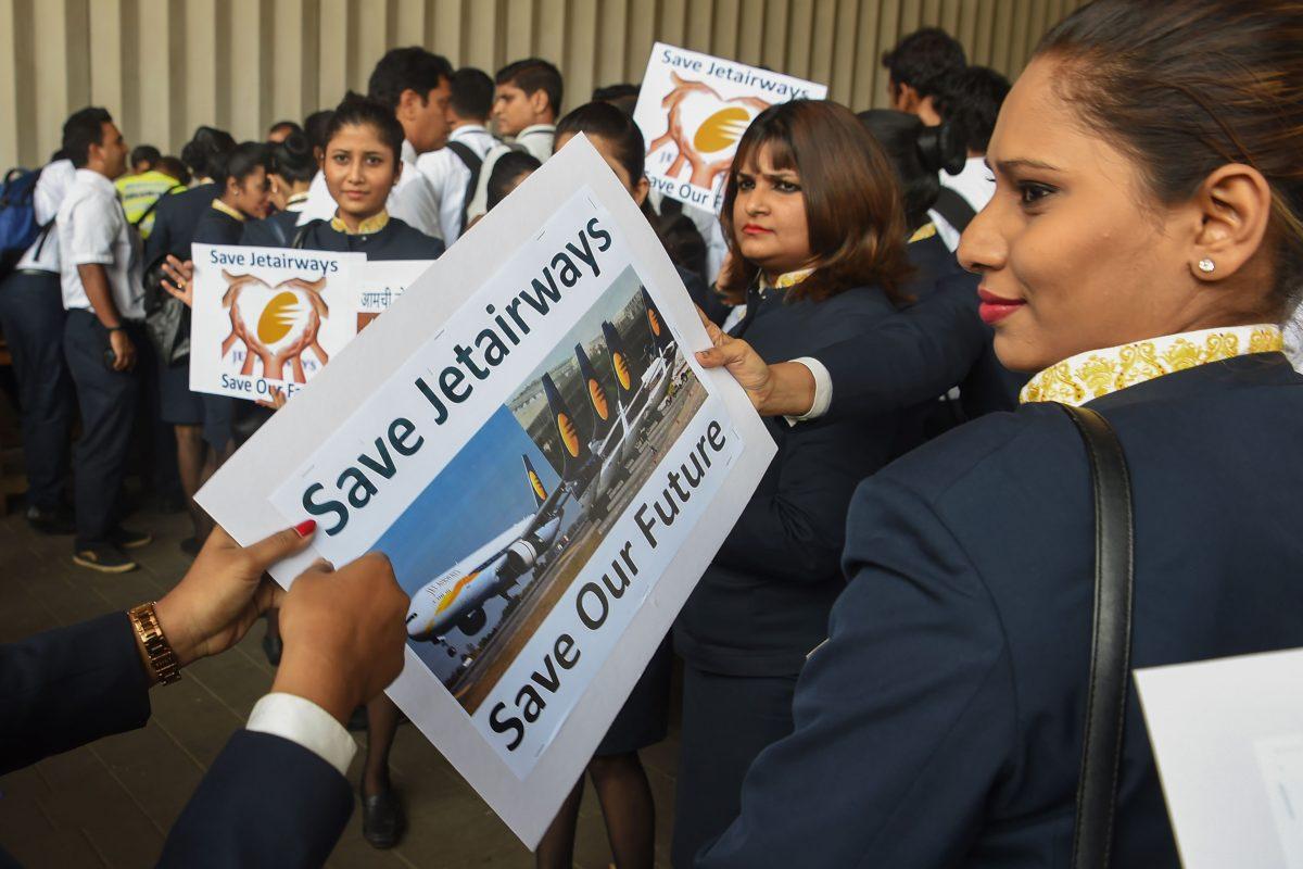 Jet Airways employees distribute placards as they gather for a protest march at the Chattrapati Shivaji International airport in Mumbai, on April 12, 2019. (Indranil Mukherhee/AFP/Getty Images)