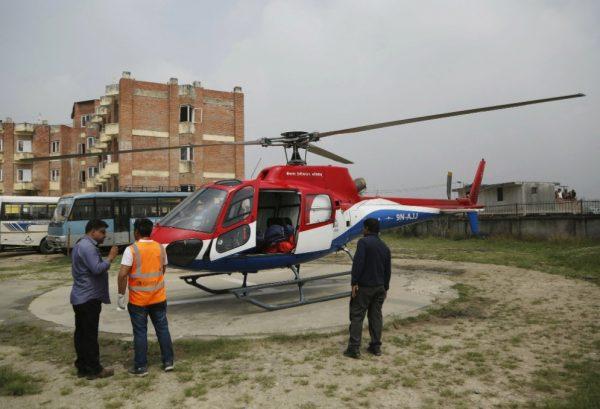 Hospital officials prepare to unload the body of a plane crash victim outside the Teaching Hospital in Kathmandu, Nepal, Sunday, April 14, 2019. (Niranjan Shrestha/AP Photo)