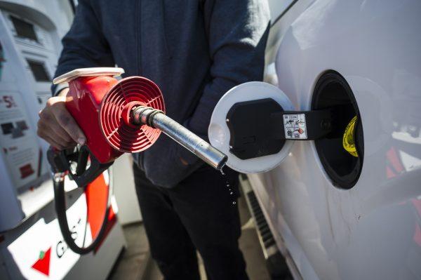 A man fills up his truck with gas in Toronto, on April 1, 2019. The Supreme Court of Canada will hear a federal-provincial legal battle over carbon pricing starting Sept. 22. (The Canadian Press/Christopher Katsarov)