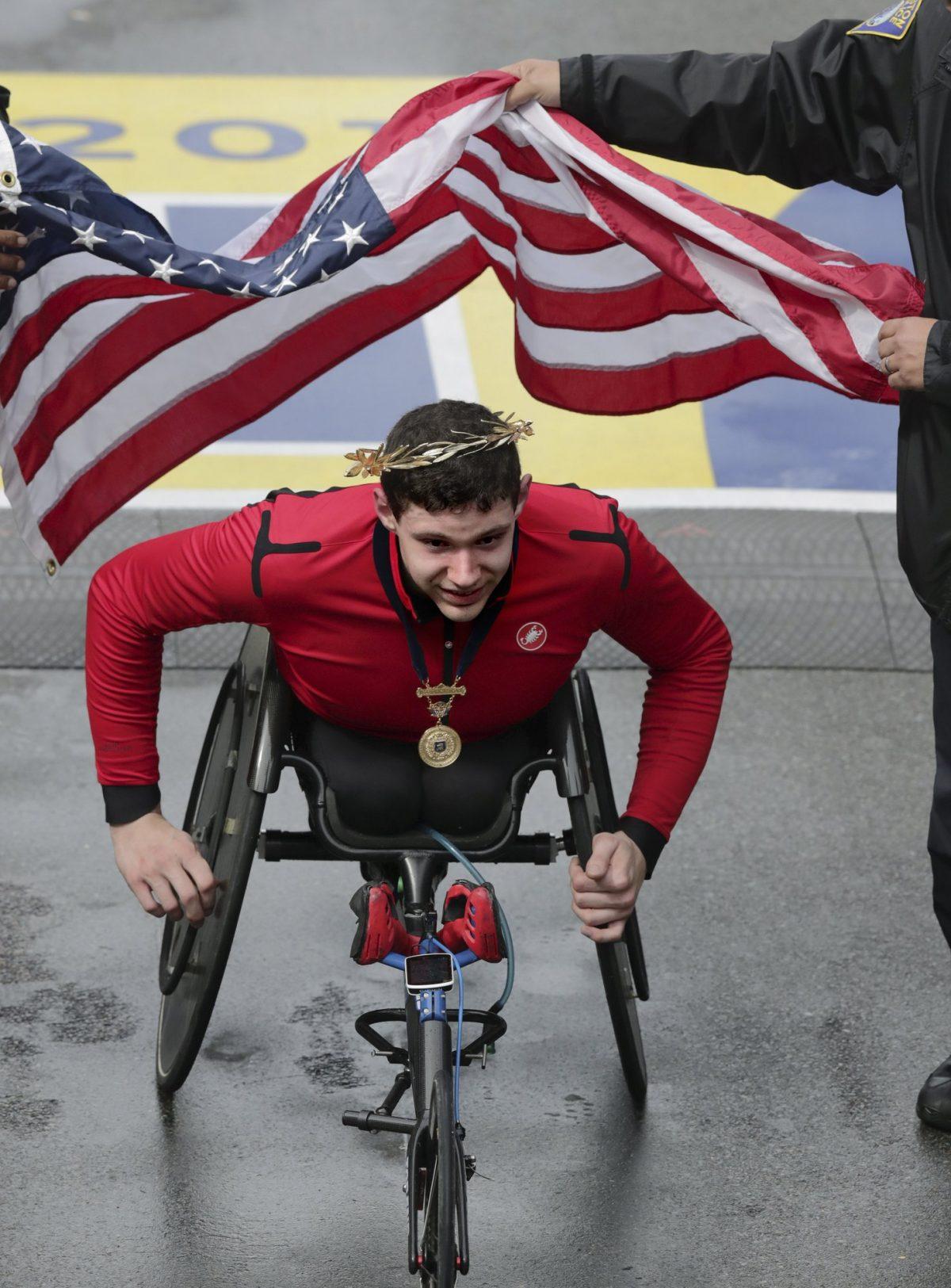 Daniel Romanchuk, of Urbana, Ill., wears the victor's wreath after winning the men's handcycle division of the 123rd Boston Marathon, in Boston on April 15, 2019. (Charles Krupa/AP Photo)