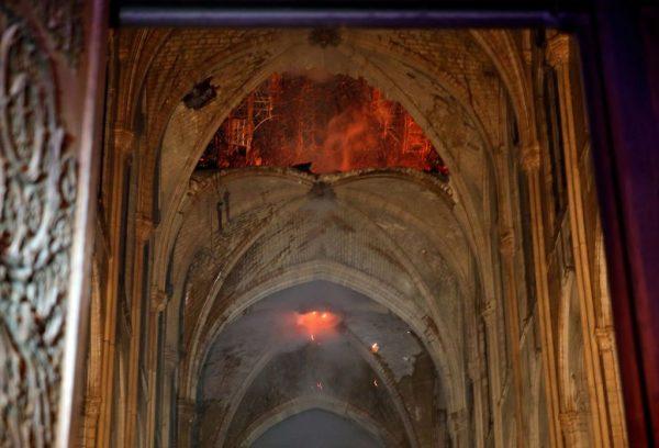Flames and smoke are seen as the interior of the Notre-Dame Cathedral continued to burn on April 15, 2019. (Philippe Wojazer/AFP/Getty Images)