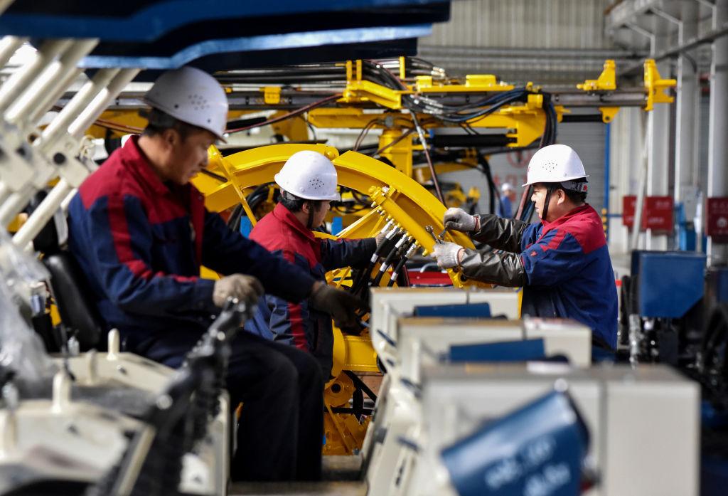 Employees work on a drilling machine production line at a factory in Hebei Province, China, on November 14, 2018. (STR/AFP/Getty Images)