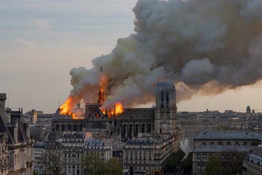 Smoke billows as flames burn through the roof of the Notre Dame Cathedral on April 15, 2019, in the French capital Paris. FABIEN BARRAU/AFP/Getty Images