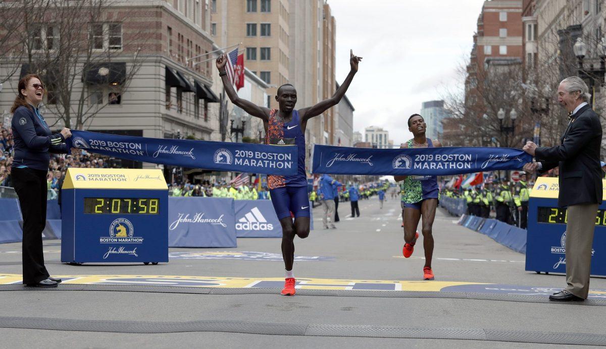 Lawrence Cherono, of Kenya, breaks the tape to win the 123rd Boston Marathon in front of Lelisa Desisa, of Ethiopia, right, in Boston on April 15, 2019. (Winslow Townson/AP Photo)