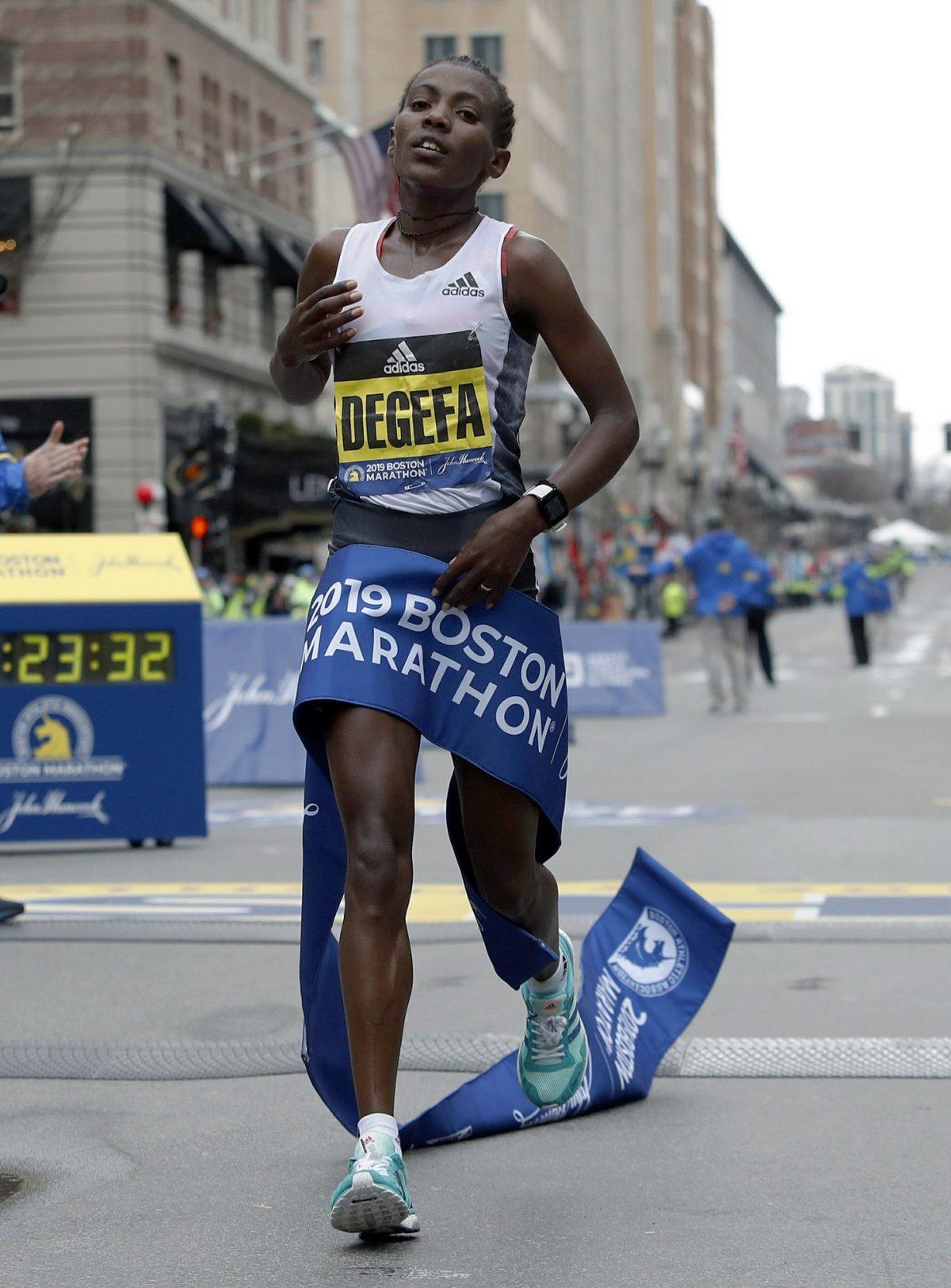 Worknesh Degefa, of Ethiopia, breaks the tape to win the women's division of the 123rd Boston Marathon in Boston on April 15, 2019. (Winslow Townson/AP Photo)