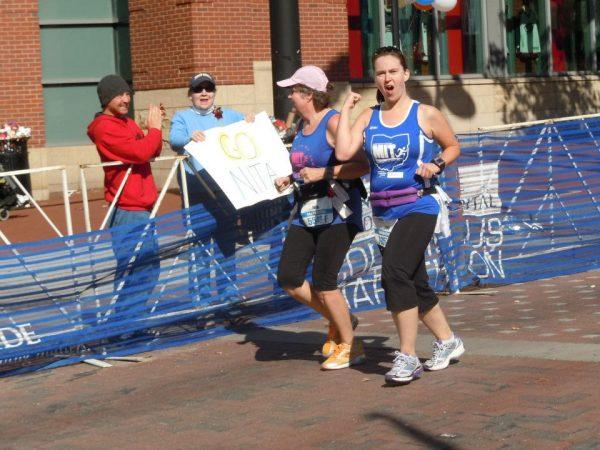 Nita Sweeney (L) with her friend Julie DeBord as they cross the finish line of the 2012 Columbus Marathon. (Courtesy of Sue Nivam)