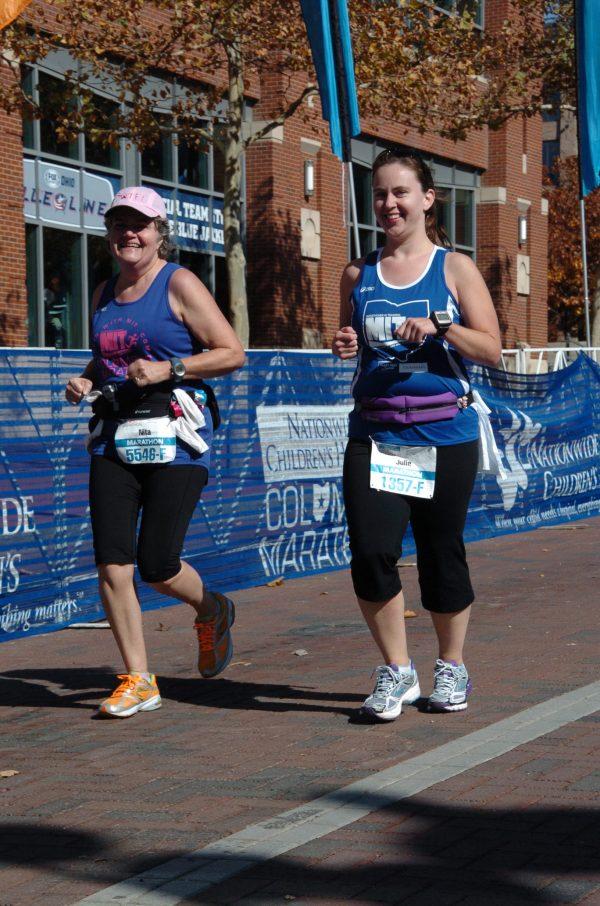 Nita Sweeney (L) running with her friend Julie DeBord during the 2012 Columbus Marathon. (Courtesy of MarathonFoto)