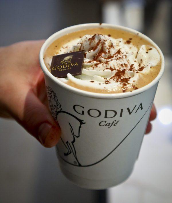 A barista shows a signature cafe mocha with whip cream at Godiva's new cafe in N.Y., on April 16, 2019. (Bebeto Matthews/AP)