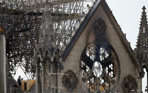 A worker checks on a wooden support structure placed on the Notre Dame Cathedral in Paris, on April 17, 2019. (Francois Mori/AP Photo)