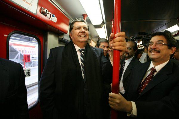 Peru's outgoing President Alan Garcia, left, ride the soon to be inaugurated Line 1 electrical train system in Lima, Peru, on July 11, 2011. (Martin Mejia/File via AP)