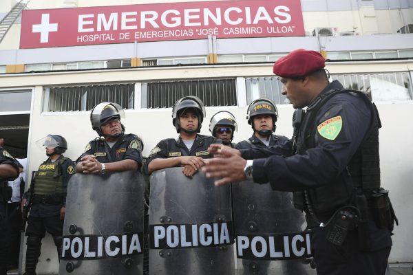 Peru's police officers stand guard at the emergency hospital Casimiro Ulloa where former Peruvian President Alan Garcia was taken after he shot himself in his neck, in Lima, Peru, on April 17, 2019. (Martin Mejia/AP)