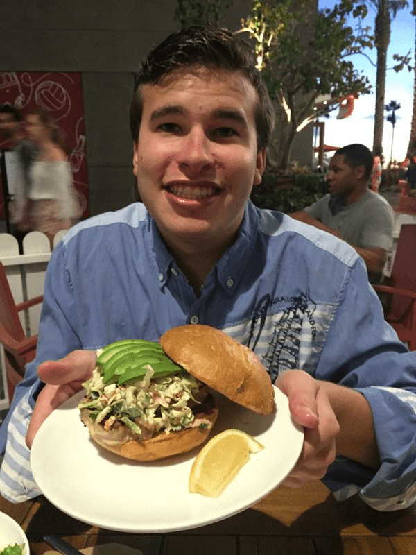 Julen Ucar with the salmon club sandwich which features his Ausome Sauce in an aioli. (Courtesy of Ways & Means Oyster House)