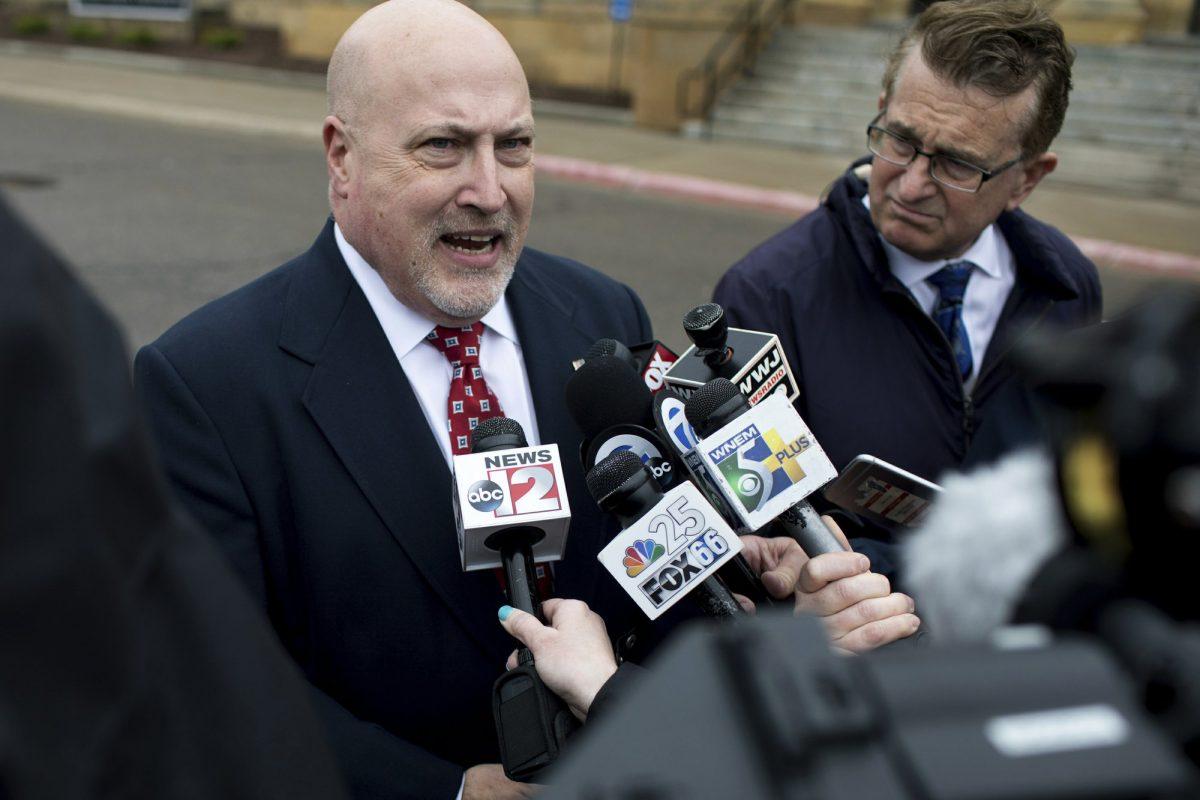 Retired Bishop Airport police Lt. Jeff Neville speaks to reporters outside the federal courthouse in Flint, Mich., on April 18, 2019. (Kaiti Sullivan/The Flint Journal via AP)