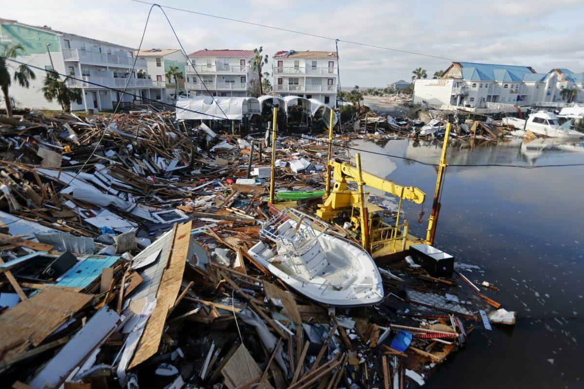 In this file photo, a boat sits amidst debris in the aftermath of Hurricane Michael in Mexico Beach, Fla. on Oct. 11, 2018. Weather forecasters have posthumously upgraded last fall's Hurricane Michael from a Category 4 storm to a Category 5. (Gerald Herbert/AP Photo, File)