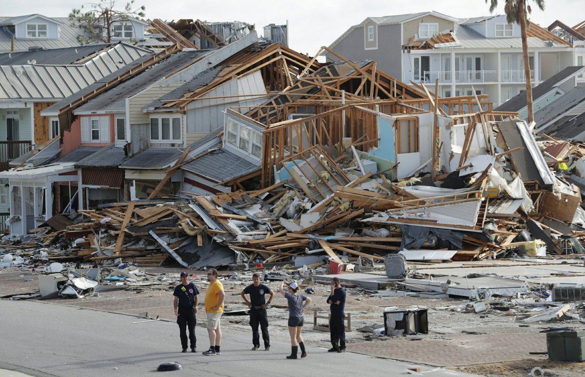 Rescue personnel perform a search in the aftermath of Hurricane Michael in Mexico Beach, Fla. on Oct. 11, 2018. Weather forecasters have posthumously upgraded last fall's Hurricane Michael from a Category 4 storm to a Category 5. (Gerald Herbert/AP Photo, File)