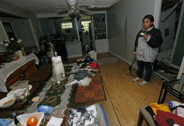 Jacqualynn Qualls calls to her mother in the tree-damaged living room of their Learned, Miss., home, following severe weather that hit the small community, on April 18, 2019. (Rogelio V. Solis/Photo via AP)