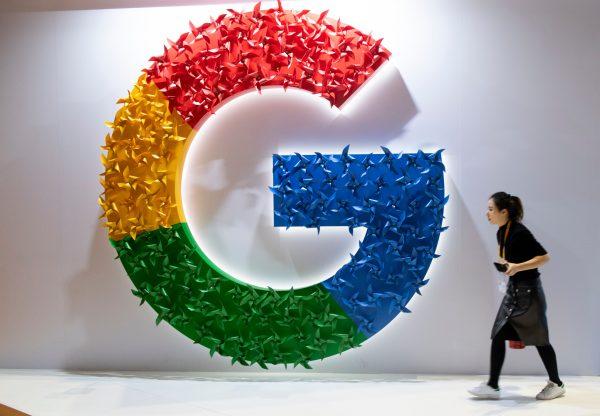 A woman passing a booth of Google at the first China International Import Expo (CIIE) in Shanghai on Nov. 5, 2018. (Johannes Eisele/AFP/Getty Images)