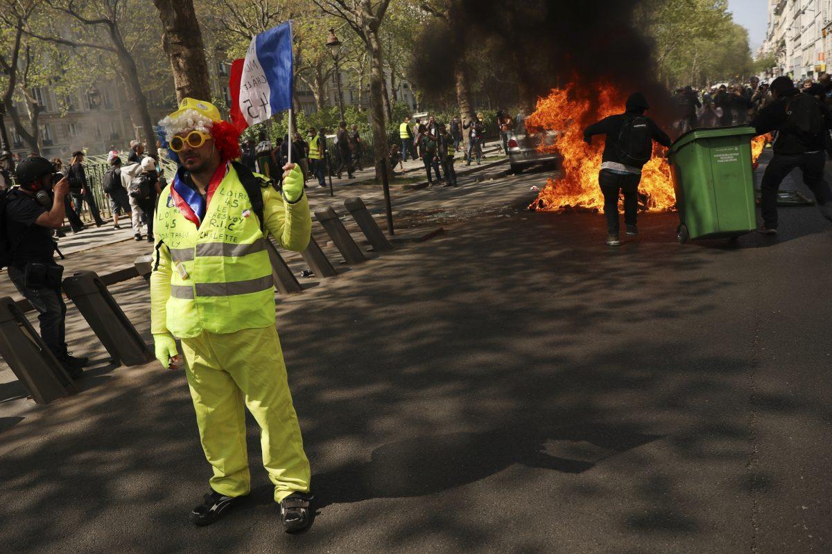 A protestors waves a French flag during a yellow vest demonstration in Paris, on April 20, 2019. (Francisco Seco/AP Photo)