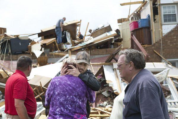 Delores Anderson, 63, center left, looks toward the wreckage of her house while comforted by friends and neighbors in Franklin County, Va., on April 19, 2019. (Heather Rousseau/The Roanoke Times via AP)