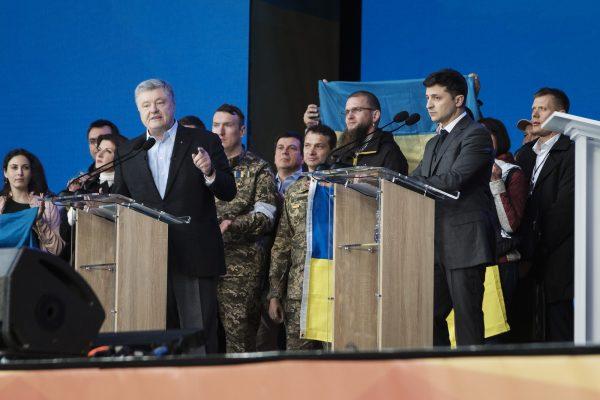 Incumbent Ukrainian President Petro Poroshenko (L) debates Volodymyr Zelensky (R) at a stadium event in Kiev on April 19, 2019. (Chris Collison for The Epoch Times)