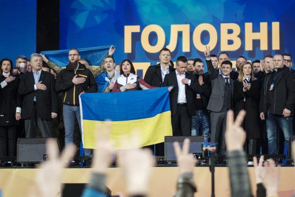 Volodymyr Zelensky (R) signals to his supporters following a debate with Incumbent Ukrainian President Petro Poroshenko (R) at a stadium event in Kiev on April 19, 2019. (Chris Collison for The Epoch Times)