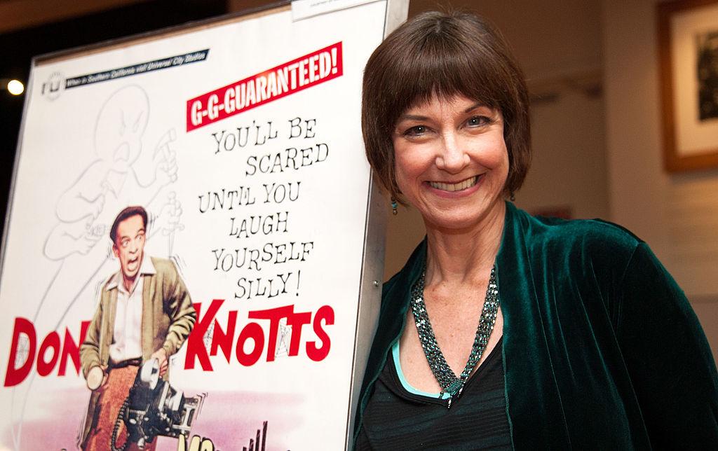 Karen Knotts poses by her famous father's movie poster in 2012 (©Getty Images | <a href="https://www.gettyimages.com/detail/news-photo/actress-karen-knotts-attends-the-academy-of-motion-picture-news-photo/154843580">Valerie Macon</a>)