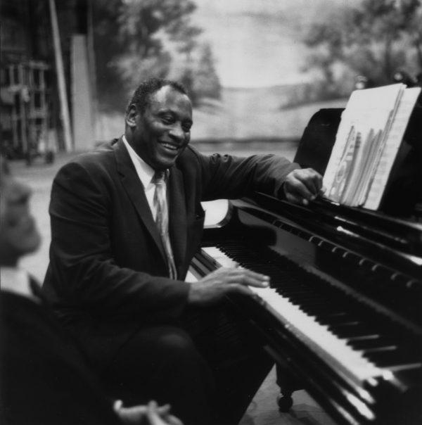 American singer, acclaimed actor of stage and screen, political activist and civil rights campaigner Paul Robeson (1898 - 1976), rehearses in relaxed mood at the piano on July 22, 1958. (Keystone Features/Getty Images)