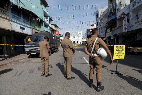 Security personnel observe three minutes of silence as a tribute to victims near St. Anthony Shrine in Colombo, Sri Lanka, on April 23, 2019. (Dinuka Liyanawatte/Reuters)