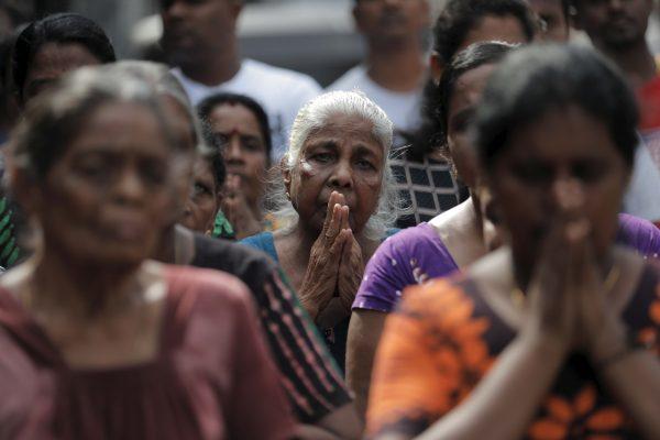 People pay tribute to victims two days after a string of suicide bomb attacks on churches and luxury hotels across the island on Easter Sunday, during a memorial service in Colombo, Sri Lanka, on April 23, 2019. (Dinuka Liyanawatte/Reuters)