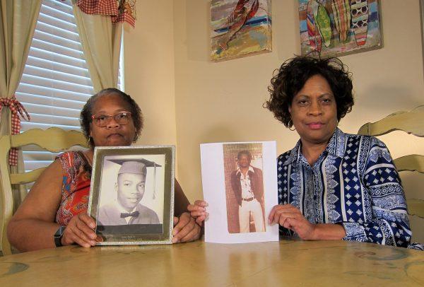 Mylinda Byrd Washington, 66, left, and Louvon Byrd Harris, 61, hold up photographs of their brother James Byrd Jr. in Houston, on April 10, 2019. (Juan Lozano/Photo via AP)