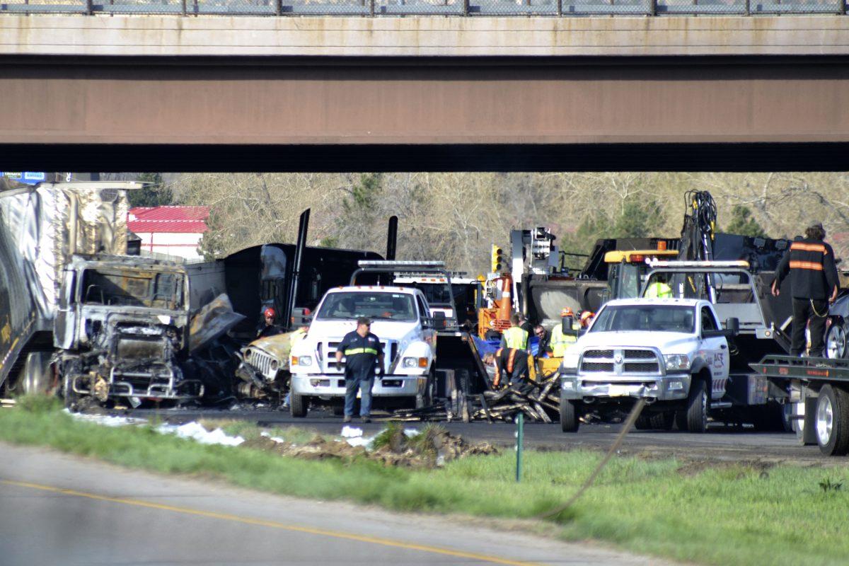Authorities survey the scene of a fiery crash on I-70 near Colorado Mills Parkway that shut down the highway in both directions o April 26, 2019. (AP Photo/Peter Banda)